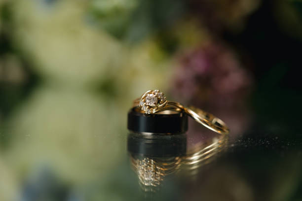 istock Golden wedding ring on floral background, Wedding background 1936387164