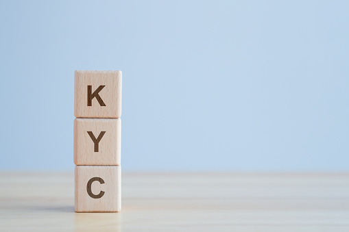 KYC on wooden cubes. know your customer for protect financial institutions against fraud, corruption, money laundering and terrorist financing. Business verifying the identity of its clients concept.