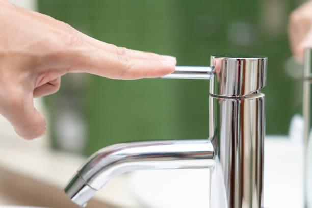 istock Save water. Man keeps turning off the running water in the bathroom to protect environment. Greening planet, reduce global warming, Save world, life, future, risk energy, crisis , water day. 1936473449
