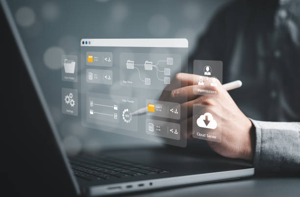istock Businessman use computer laptop to manage file document on server. DMS, Cloud backup online documentation, and digital storage software. Database upload, download, share, and permission grant access. 1936475536