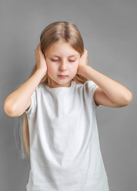 istock Little girl holding her head. 1936538312