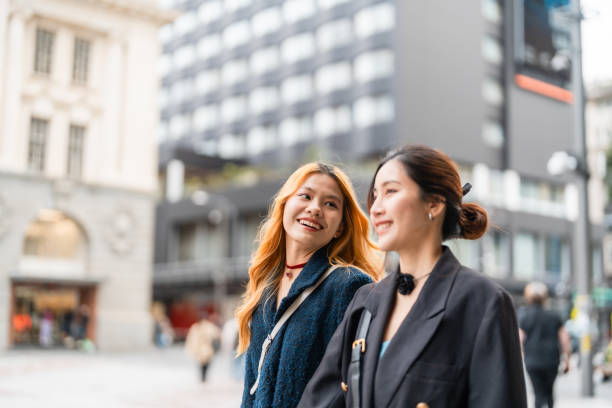 istock Young friends conversating with each other in city. 1936540453