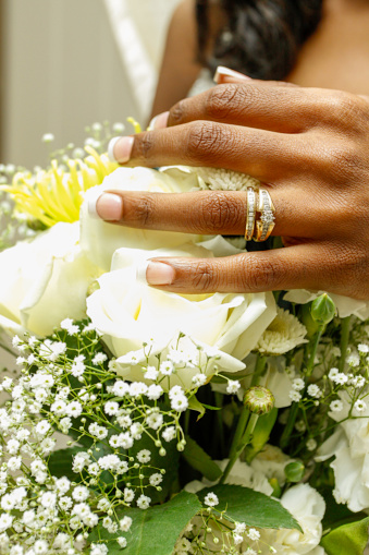 Brides hand with Bouquet showing rings