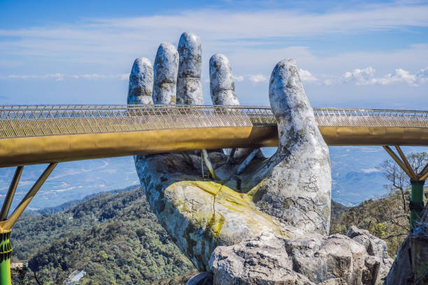 Da Nang, Vietnam: Famous tourist attraction - Golden bridge at the top of the Ba Na Hills, Vietnam Da Nang, Vietnam, 28 december 2020: Famous tourist attraction - Golden bridge at the top of the Ba Na Hills, Vietnam. bridge hand stock pictures, royalty-free photos & images