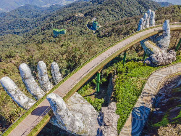 Da Nang, Vietnam: Famous tourist attraction - Golden bridge at the top of the Ba Na Hills, Vietnam Da Nang, Vietnam, 28 december 2020: Famous tourist attraction - Golden bridge at the top of the Ba Na Hills, Vietnam. bridge hand stock pictures, royalty-free photos & images