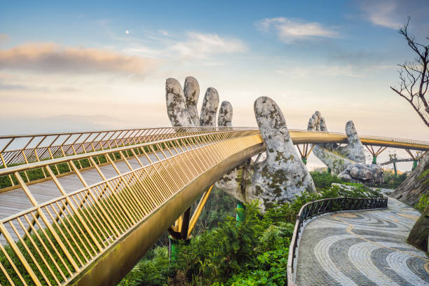 Da Nang, Vietnam: Famous tourist attraction - Golden bridge at the top of the Ba Na Hills, Vietnam Da Nang, Vietnam, 28 december 2020: Famous tourist attraction - Golden bridge at the top of the Ba Na Hills, Vietnam. bridge hand stock pictures, royalty-free photos & images