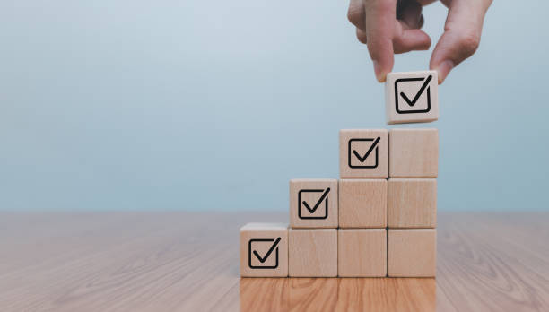 istock Checklist concept, business person checklist tick answer sign in checkbox, validation online questionnaire quality control document, man use pen to tick correct sign mark in checkbox form. 1936605533