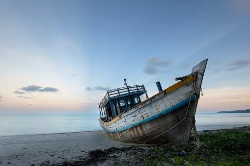 Abandoned boat wreck at the coast of Havelock or Swaraj Dweep island in Andaman and Nicobar archipelago at sunset