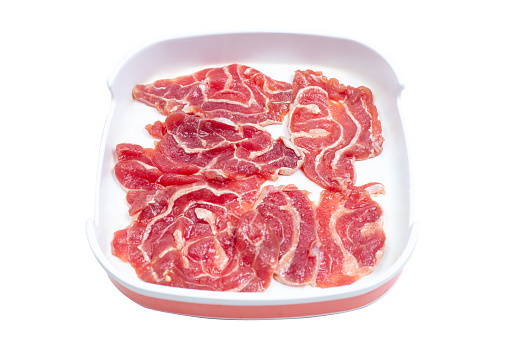 Fresh raw offal sliced on square plate isolated on white background, hot pot ingredients.