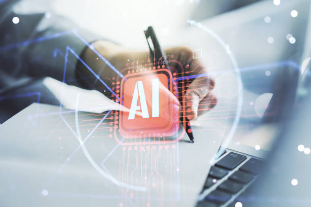 istock Double exposure of creative artificial Intelligence abbreviation with hand writing in notepad on background with laptop. Future technology and AI concept 1936656438
