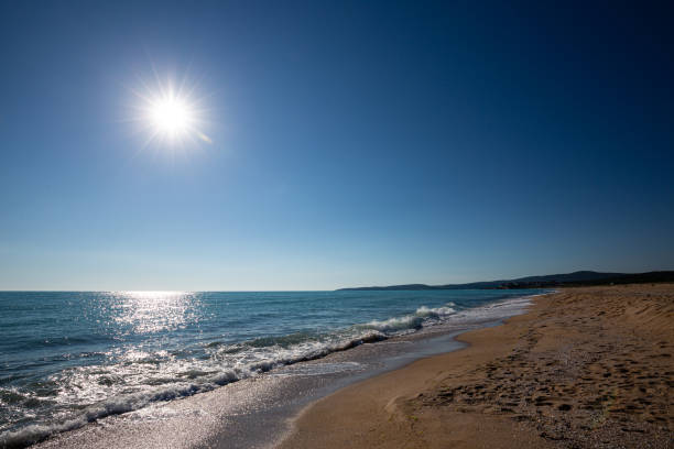istock Seascape with beach, waves, sun and empty blue sky 1936659616