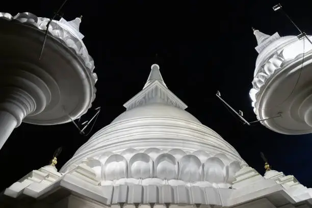 White domes of the Mahamevnawa Amawatura Monastery are under night sky. Buddhist Monastery located in Malabe district of Colombo, Sri Lanka