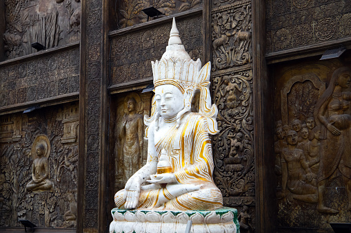White Buddha statue at Gangaramaya Temple, it is one of the most important temples in Colombo, Sri Lanka