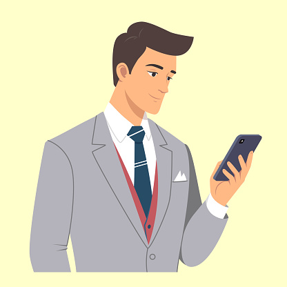 Young business man in suit using his phone