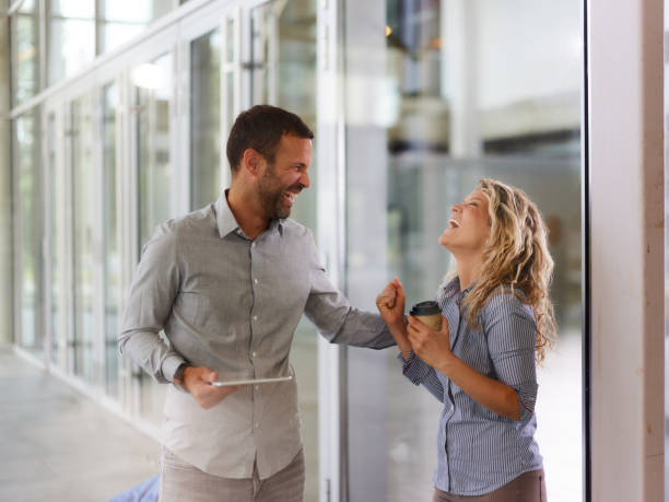 istock Cheerful entrepreneurs talking about success in a hallway. 1936717466