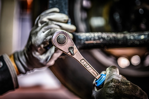 Close up of mechanics hands in glows.