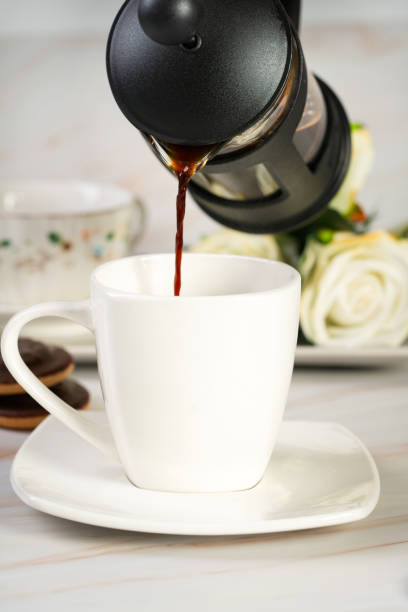istock Pouring black coffee into a cup from a french press 1936759146