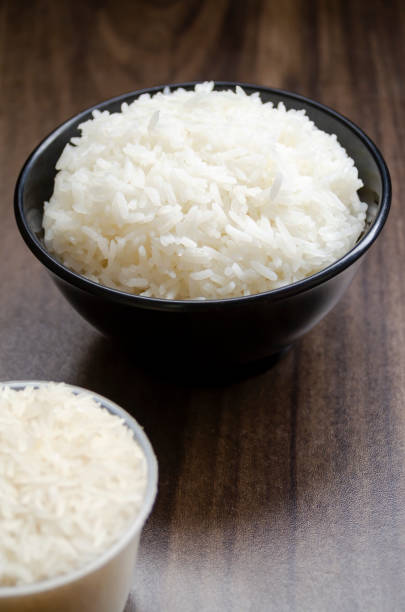 istock Rice in cup on wooden table blurred 1936760684