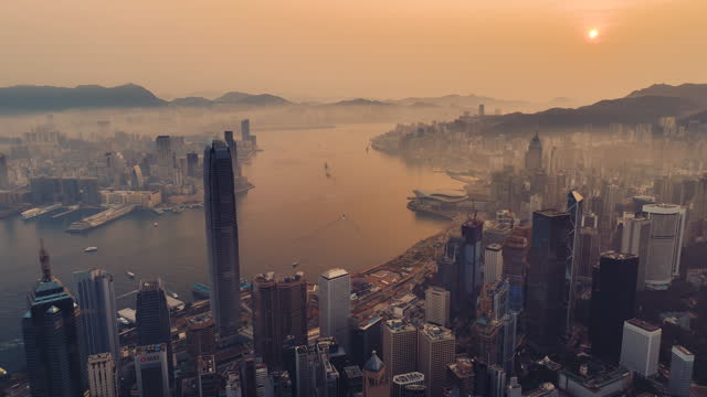 Aerial dolly left Hong Kong cityscape at sunrise