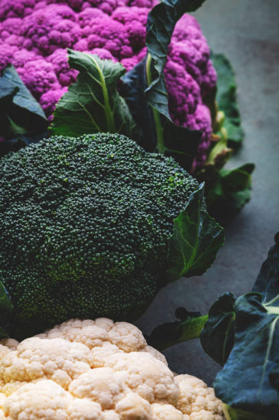 istock White and lilac cauliflower, broccoli cabbage from farm market on old rustic green table 1936778143