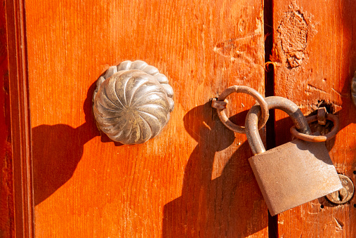 Door with padlock and knob