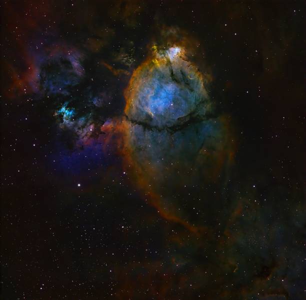 Deep space real astrophotography image view of the colorful Fish Head Nebula IC 1795. The Nebula is located in the Perseus Arm of the Milky Way in the constellation Cassiopeia at a distance of 7,500 light-years from Earth.