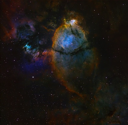 Deep space real astrophotography image view of the colorful Fish Head Nebula IC 1795. The Nebula is located in the Perseus Arm of the Milky Way in the constellation Cassiopeia at a distance of 7,500 light-years from Earth.