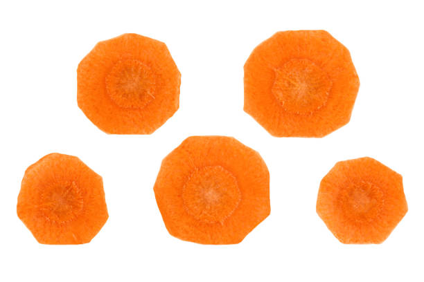 Circles of peeled carrots isolated on a white background.