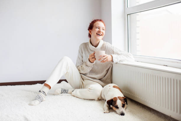 istock Young Woman Drinking hot coffee at white room 1936828390