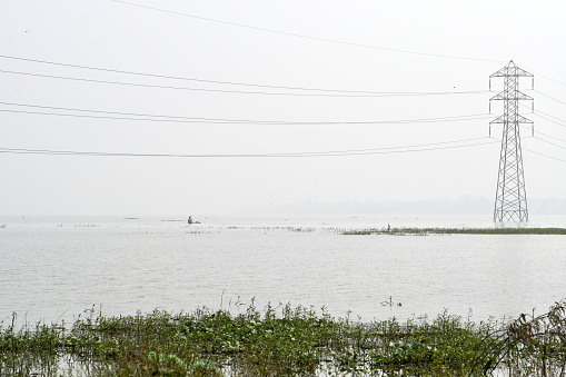 High voltage electric transmission tower installed at the middle of a lake in Chennai, Tamilnadu.
