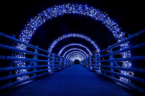 A beautifully illuminated bridge tunnel shining brightly amidst the darkness of the night