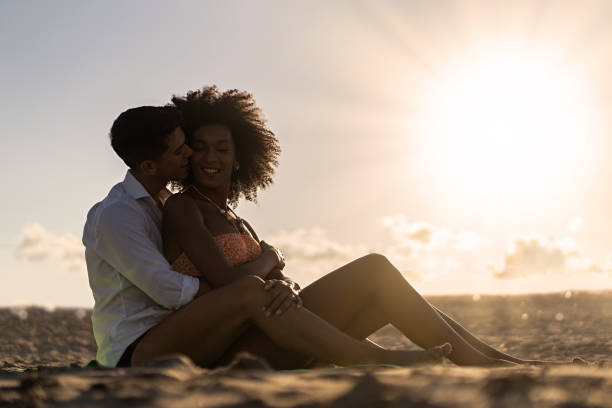 istock Romantic multiethnic couple hugging at sunset 1936866722