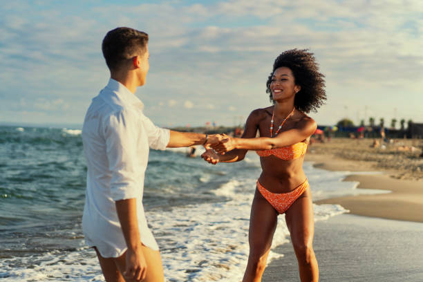 istock Joyful multiethnic Couple Dancing on the Beach 1936866726