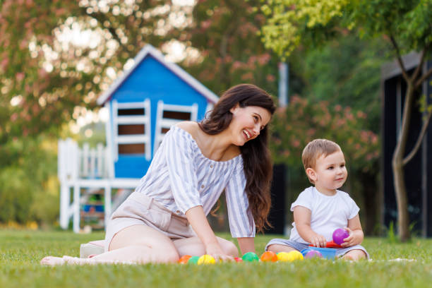 istock Mother and child playing while on a picnic in the park 1936898189
