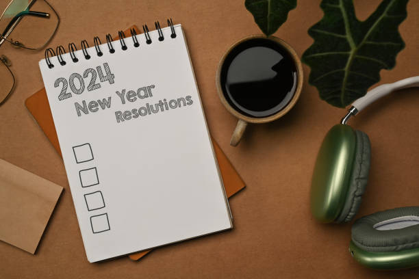 istock 2024 New Year resolutions on a spiral notebook. Resolutions, plan and goals concept 1936898699