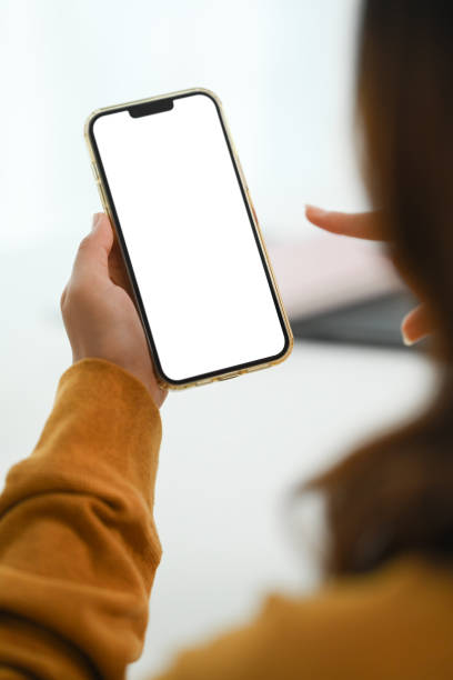 istock Woman hands holding mobile phone with blank screen for advertising text message. 1936899301