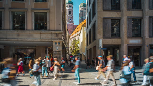 Time lapse of Crowd of People tourist walking and sightseeing attraction at Frauenkirche Church and shopping street in the city centre of Munich in summer, Munich, Bavaria, Germany