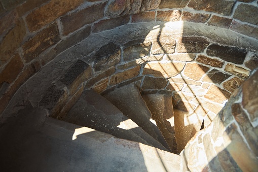 Spiral staircase, descent from a high stone tower