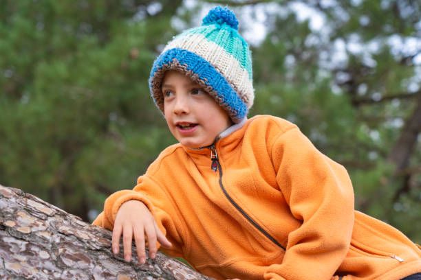 Boy relaxing in a forest with warm clothes