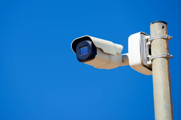 istock Close-up of a surveillance camera and clear sky 1936926162