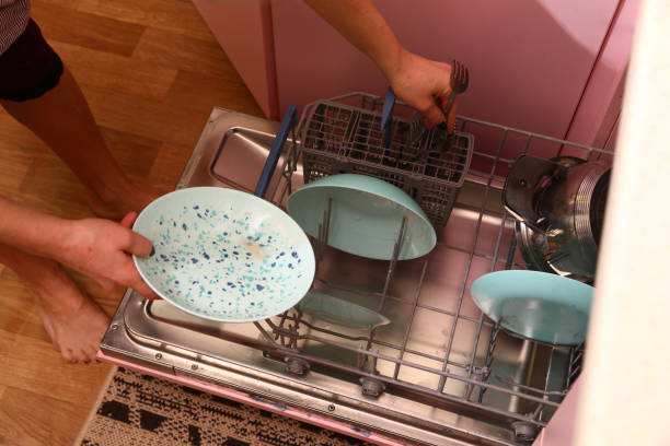 istock Placing dirty dishes in the dishwasher 1936927241