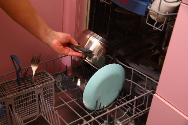 istock Placing dirty dishes in the dishwasher 1936935439