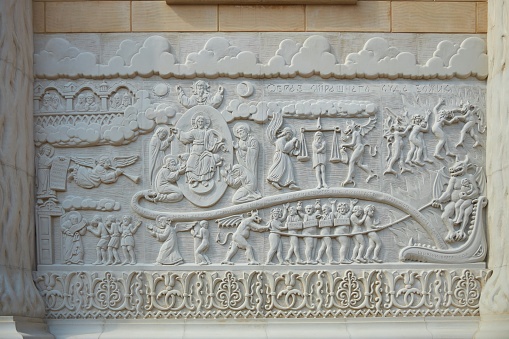 Kabardinka, Russia. - March 22, 2022: Bas-reliefs on the wall of the building in the form of scenes from life. Historical style.