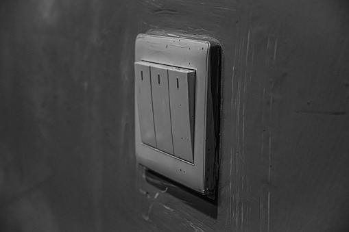 a light switch attached to the wall of the room