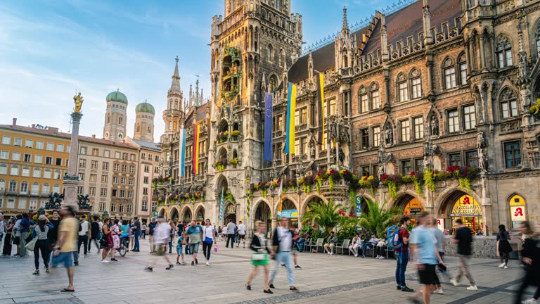 Time lapse of Crowd of People tourist walking and sightseeing attraction at Marienplatz a central square in the city centre of Munich and New Town Hall in summer, Munich, Bavaria, Germany