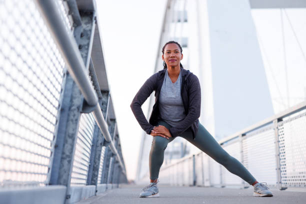 Woman warming up for morning jogging session