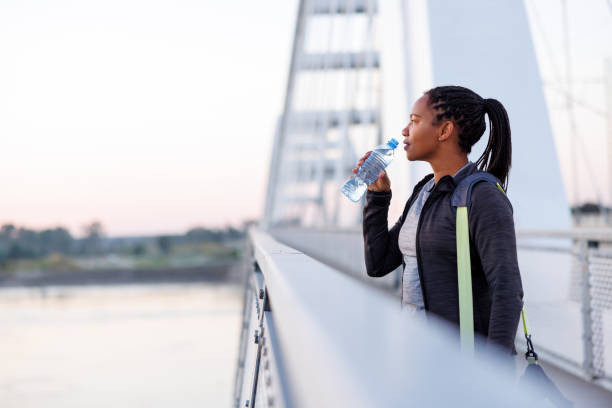 istock Woman drinking water after morning workout session 1936971097
