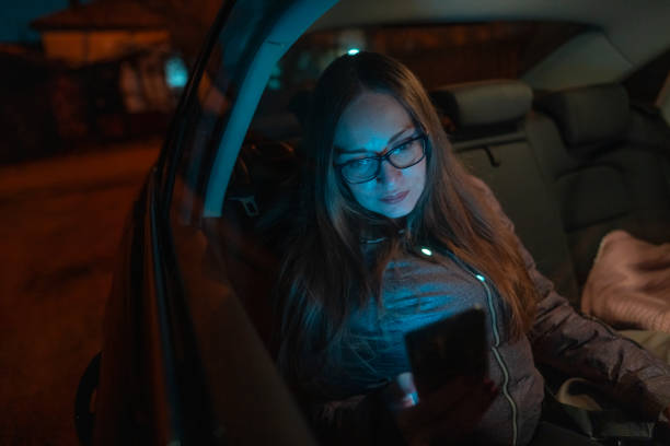 istock Woman using smart phone in car 1936973365