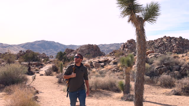 Man hikes through desert landscape