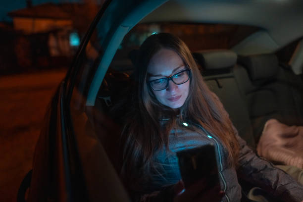istock Woman using smart phone in car 1936976574